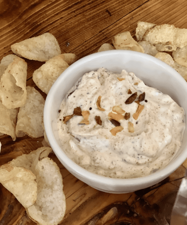 White dip with chips on wooden board.